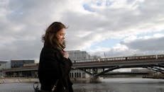 Young Woman in Winter Clothing Walking in City